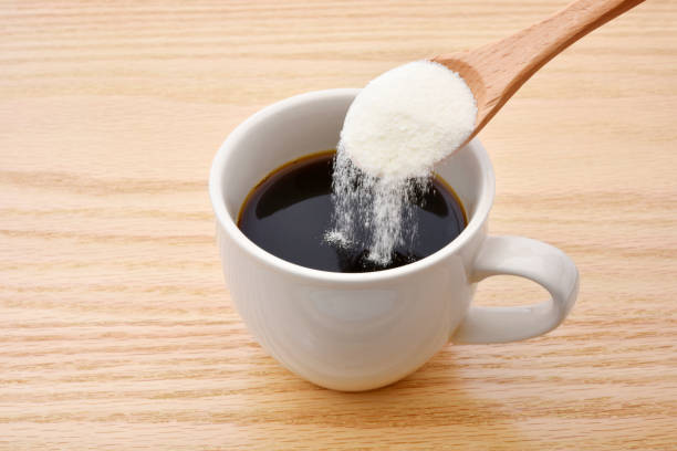 Pure collagen powder being measured with a scoop for daily protein intake
